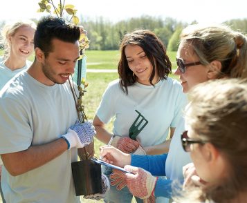group-of-volunteers-with-tree-seedlings-in-park-P7SJ7GF-1.jpg